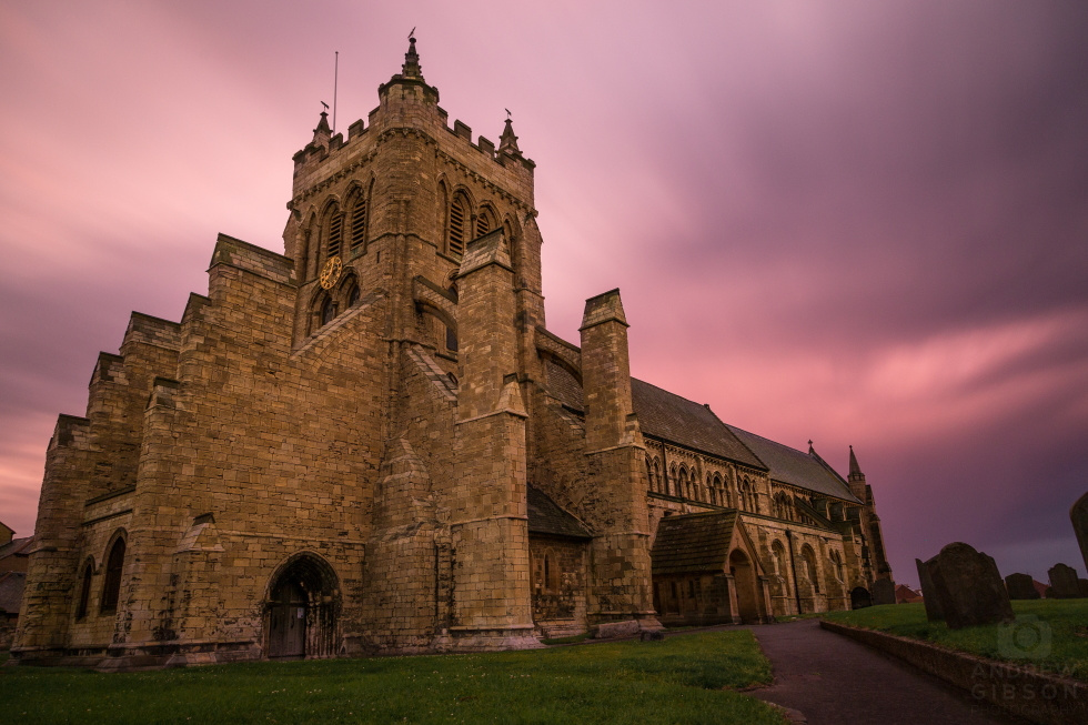 St Hilda's Church in Hartlepool, the sunset casting a pink glow in to the heavy clouds, smoothed out by long exposure.